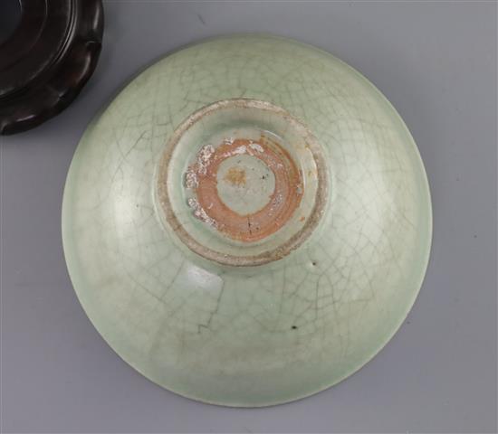 A Chinese Longquan celadon bowl, Ming dynasty, D. 18.5cm, crackle to glaze, wood stand